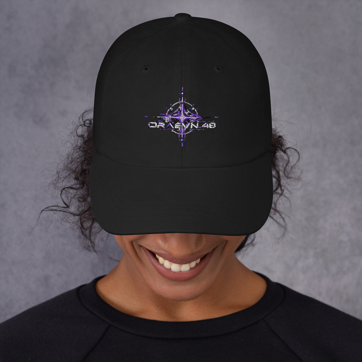 Black dad hat with embroidered ultraviolet celestial emblem, front view on model